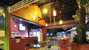 An indoor bar area with a counter, bar stools, and hanging lights. - Serene Villa (Chalong)