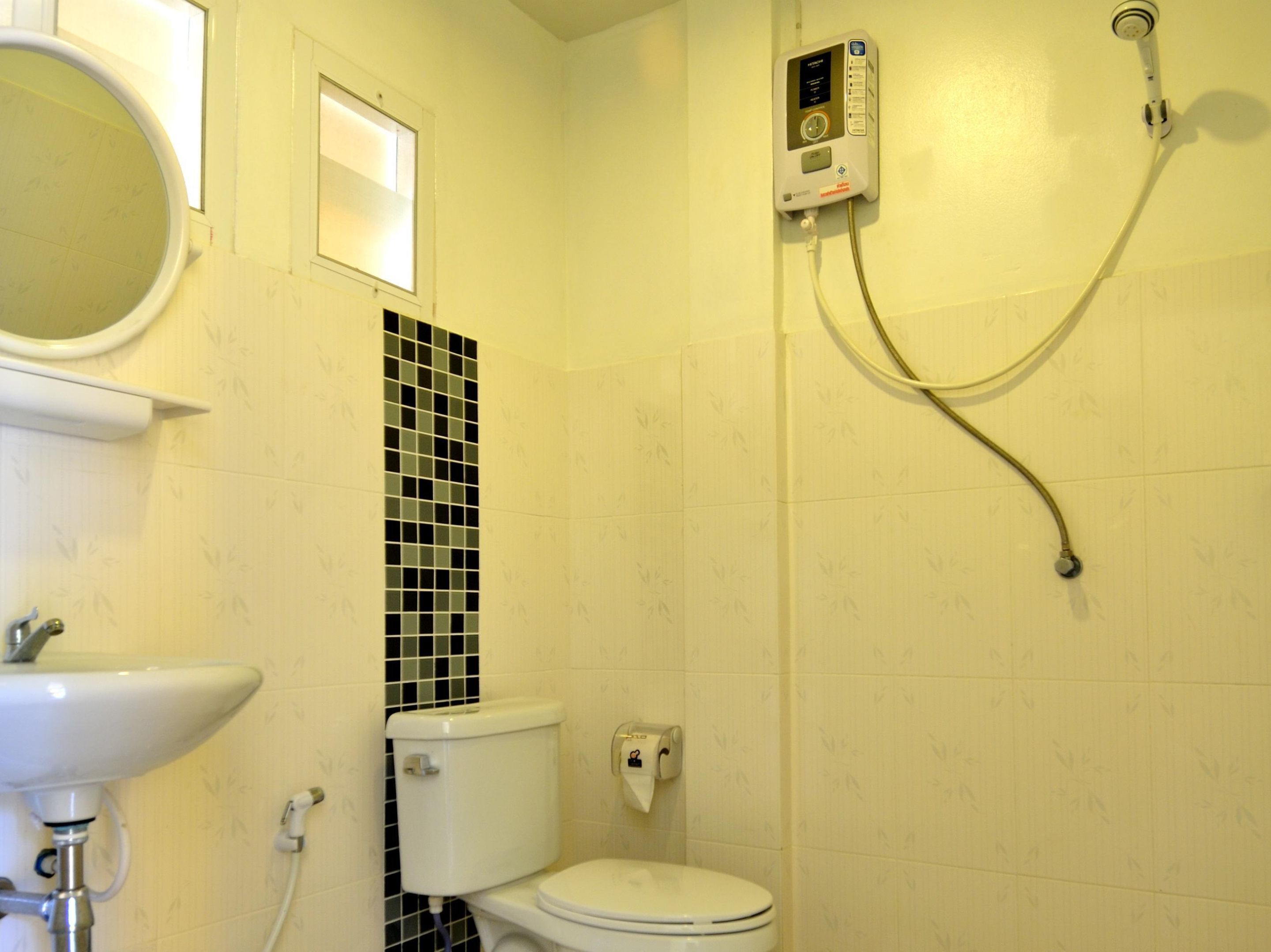 A bathroom with a toilet, a sink, and a shower.