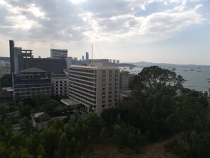 A multi-story hotel with a view of the bay and boats.