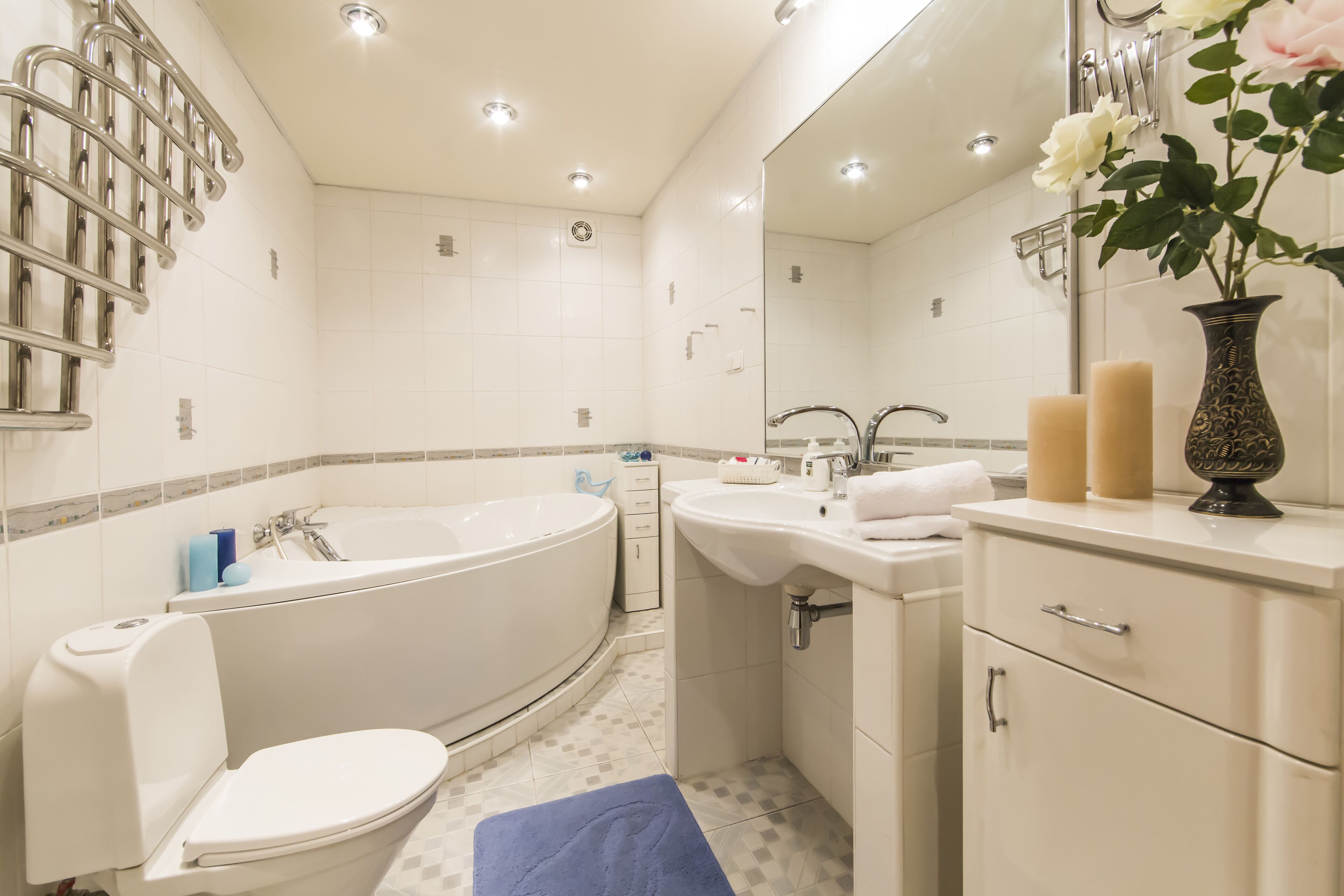 A modern bathroom with a bathtub, toilet, sink, and vanity.