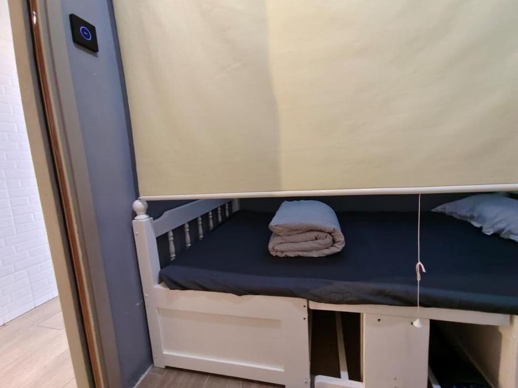 A bunk bed with a folded blanket on the top bunk.