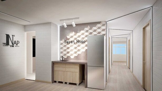 A modern bathroom with a geometric patterned wall, a wooden vanity, and a visible sink. - The Nap Mong Kok (Kowloon)