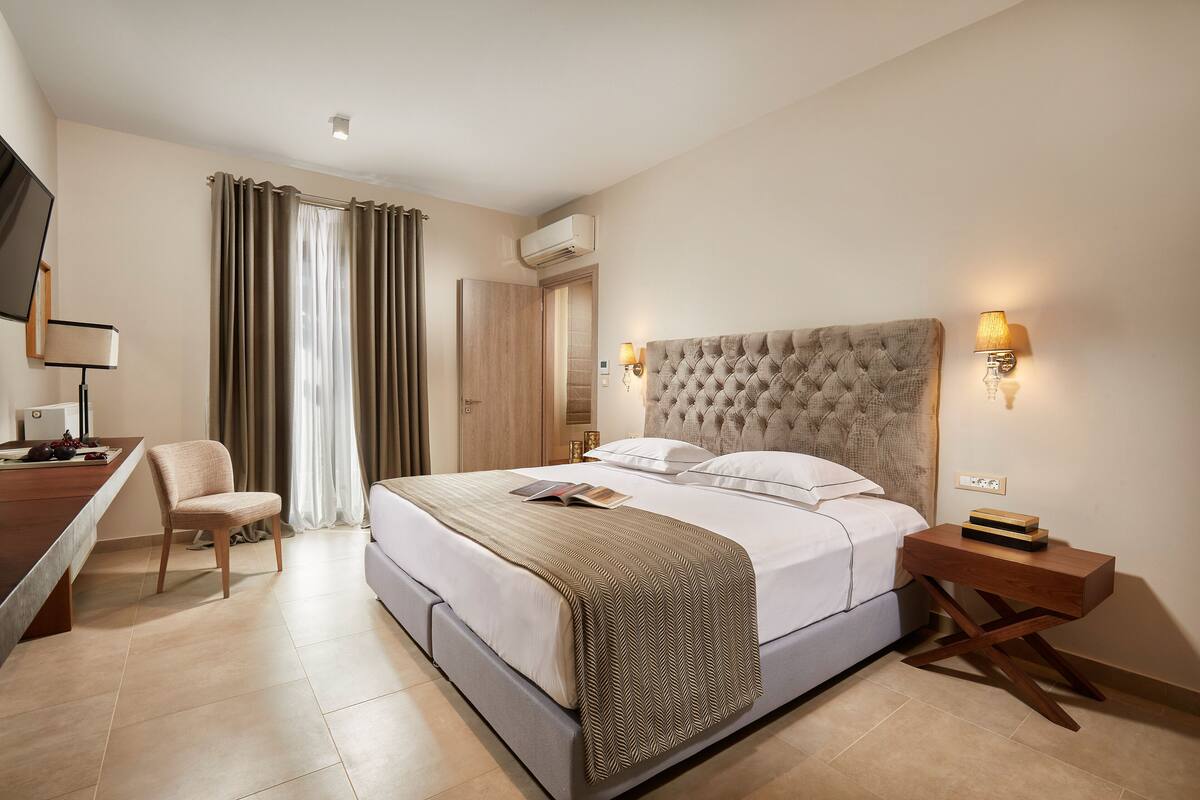 Signature Suite | Premium bedding, desk, laptop workspace, blackout drapes
