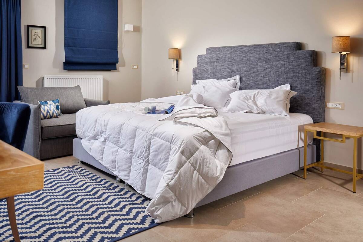 Premium bedding, desk, laptop workspace, blackout drapes