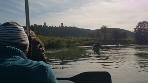 A river scene with a boat and a person paddling.