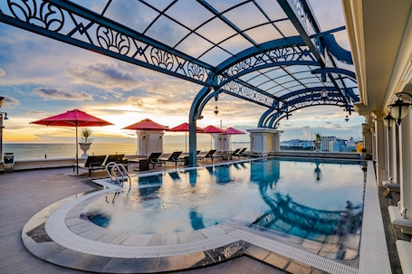 Outdoor pool, pool umbrellas, pool loungers. AVS Hotel Phu Quoc