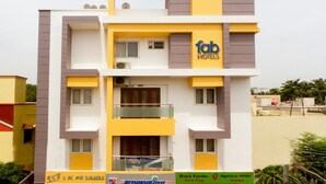 A multi-story building with the sign "fab hotels" on the facade. - Rithikha Inn (Chennai)