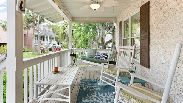 A porch with white railings, a ceiling fan, and a rocking chair. - Village Walk - 3 bedrooms, 2 1/2 bathrooms located next to the Village (Saint Simons Island)