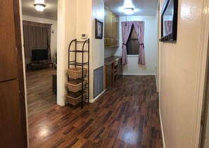Cozy retreat with a wardrobe, shelf unit, and window with curtains.