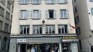 A hotel named HOTEL KRONE with a sign above the entrance and a visible flag. - Pop Up Hotel Krone Zürich (Zürich)