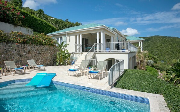 A pool area with lounge chairs and a swimming pool. - Southern Breeze: Expansive Ocean Views! Amazing Sunrises! (St. John)