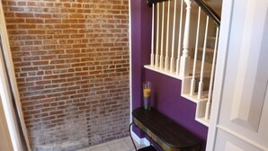 A staircase with white balusters and a purple wall. - Fun and walkable area, sleeps 9, private parking and patio, newly renovated! (St. Louis)