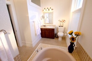 Full spa bathroom with Jacuzzi-style tub and separate shower