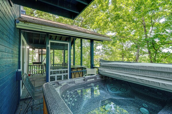 A spa area with a hot tub, outdoor seating, and a covered patio. - Getaway w/ Hot Tub in Margaritaville Lake Resort! (Osage Beach)