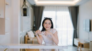 A modern living room with a marble coffee table, a sofa, and a dining area with a wooden table and chairs. - Peranakan House (Wichit)