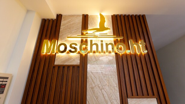 A hotel sign with the name 'Moschinolt' and a bird silhouette. - Moschino HT (Nha Trang)