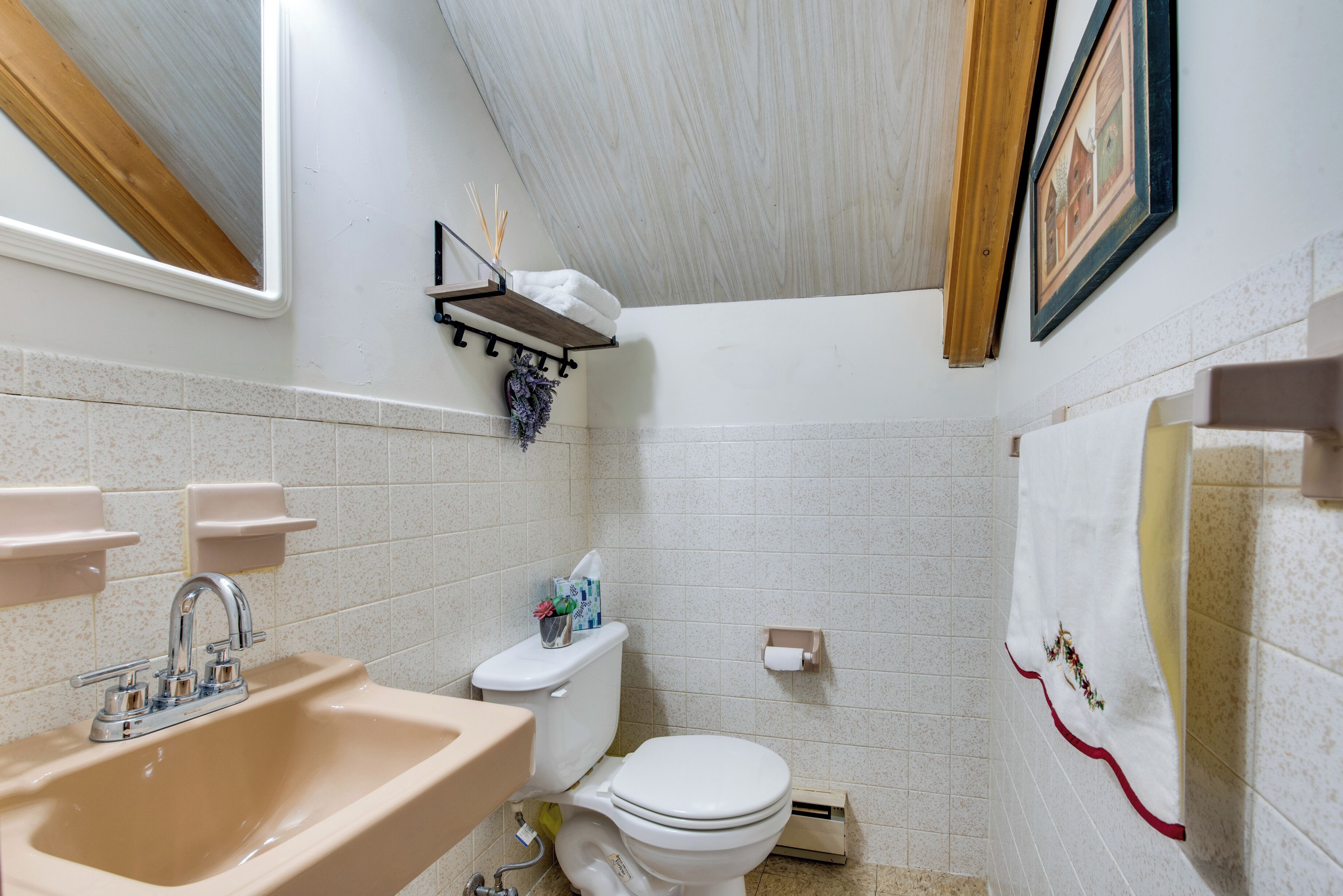 A bathroom with a sink, toilet, and shower area.
