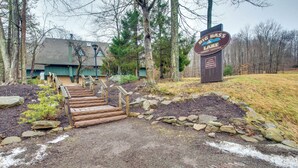 A wooden staircase leading to a building with a sign for Big Bass Lake. - Fire Pit + Community Perks: Gouldsboro Cabin! (Gouldsboro)