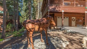 A rustic lodge with a wooden exterior, a balcony, and a stone pathway. - The Lodge: Comfort&Hospitality AC/4bdrm/10 beds/beach (Soda Springs)
