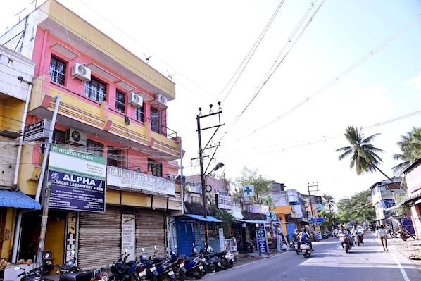 A street view with buildings, a clinic, and parked motorcycles.