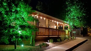 Una casa con porche, luces colgantes y un letrero que dice 'Welcome'.