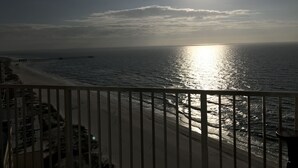 A beach with a pier extending into the ocean, viewed from a balcony with a railing. - Great rates!! PENTHOUSE BEACHFRONT!  Most Stunning View of Gulf Shores!!   (Gulf Shores)