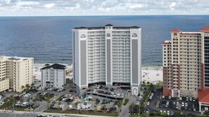 A high-rise hotel with multiple floors, a parking garage, and a view of the ocean. - Great rates!! PENTHOUSE BEACHFRONT!  Most Stunning View of Gulf Shores!!   (Gulf Shores)