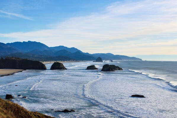 Enjoy breathtaking ocean views from this serene coastal location, surrounded by natural rock formations and majestic mountains.