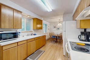 Enjoy cooking in this kitchen with microwave, stove, and coffee maker.