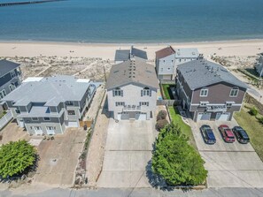 A residential area with houses, a beach, and a parking lot.