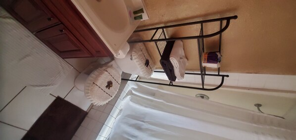 Relax in this serene space with a bathtub and shower, complemented by a convenient towel rack.