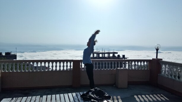 A balcony with a view of the ocean and a pier. - Shree yoga retreat (Kathmandu)