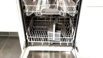 An open dishwasher with multiple racks and a control panel.