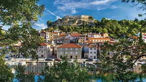 A coastal town with historic stone buildings, a marina, and a prominent castle on a hill. - Beach front home in Novigrad (Novigrad)