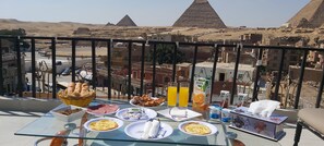 Enjoy a meal with a view of the iconic pyramids from this rooftop dining area.