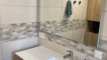 Shower, hair dryer, towels, toilet paper
