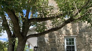 A stone building with a window and a flag.