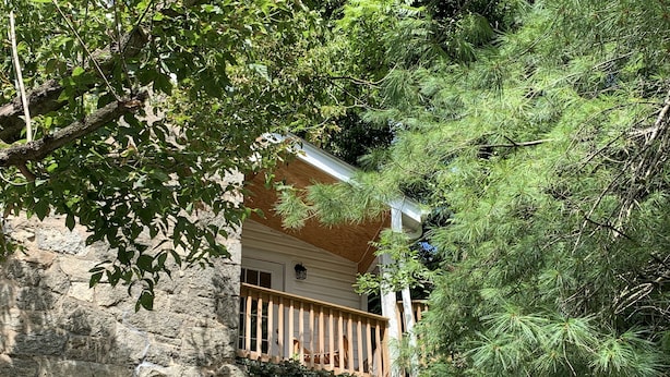A stone building with a wooden balcony.