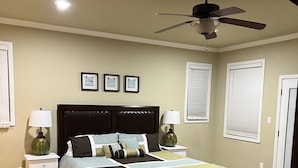 A bedroom with a bed, two nightstands, a ceiling fan, and three framed pictures on the wall. - 2/2 Condo on Lake Hamilton - Great Location! 10% discount on 7 night rental (Hot Springs)