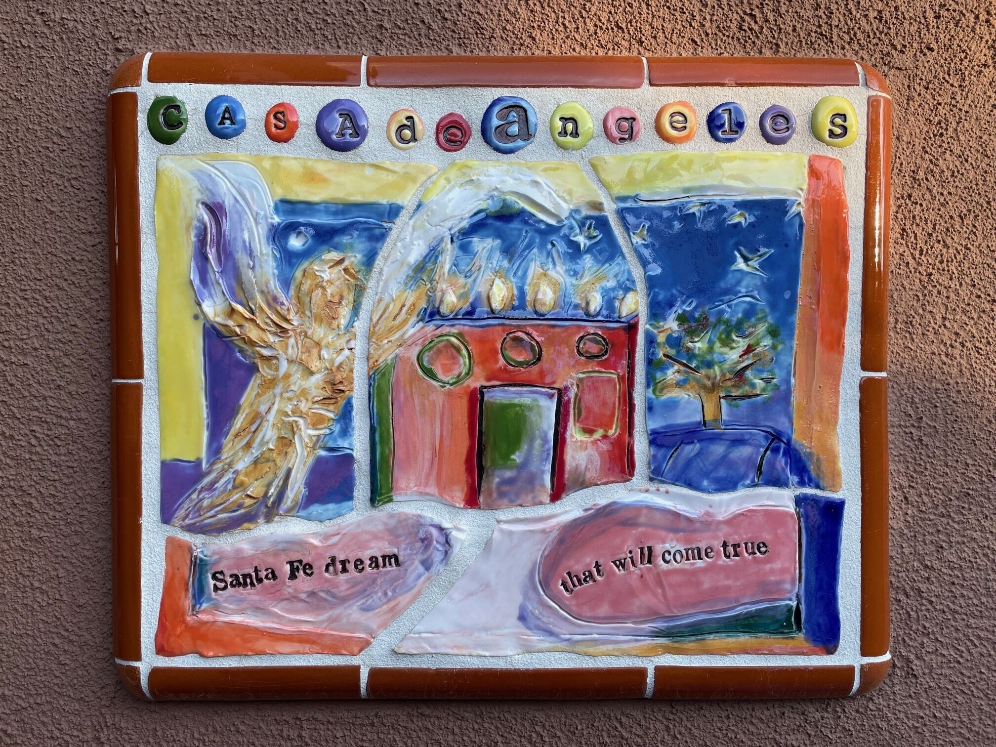 A mosaic with the text "Casanovas" and "Santa Fe dream that will come true" on a wall.
