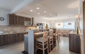 Fridge, stovetop, dishwasher, coffee/tea maker