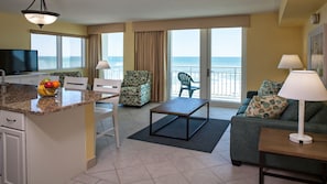 Enjoy a spacious room with a kitchen area, seating space, and ocean views from the balcony.