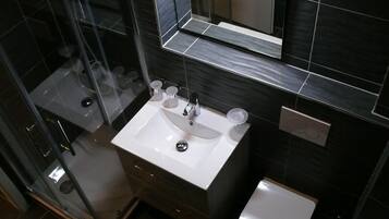 Shower, towels, soap, toilet paper