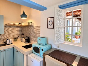 A compact kitchen with a microwave, toaster, and coffee maker. - Le Petit Bonheur • Quiet • Rooftop • 3 min to Beach (5 de Diciembre)
