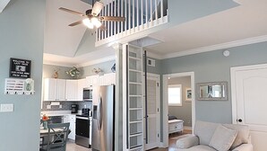 A spacious living area with a kitchen, a dining table, and a sofa.