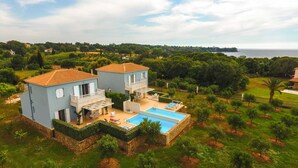 A two-story house with a swimming pool, surrounded by greenery and a view of the sea. - Betty's Villas (Pyrgos)