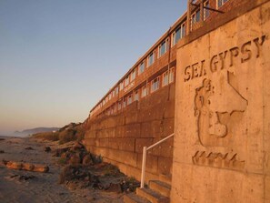 A concrete wall with the inscription "SEA GYPSY" and a relief sculpture of a face. - Stunning Beachfront Suite - Sleeps 4 - Second Floor - Pool and Sauna! (Lincoln City)