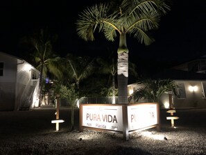 A sign for 'PURA VIDA' with a palm tree in the background.