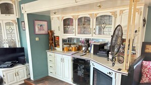 A compact living space with a kitchen area, a fireplace, and a seating area.