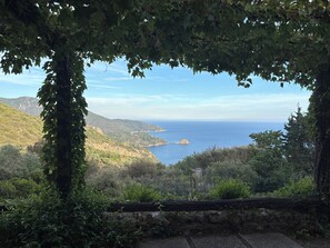 A scenic view of a coastal landscape with a stone pathway leading to a viewpoint. - Villa with panoramic veranda 'Il Riccio' (MONTE ARGENTARIO)